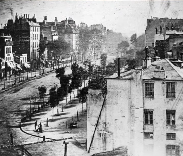 The first daguerreotype (1837). The city is Paris, and the man in the lower left-hand corner is the first person ever to be photographed in the history of photography.